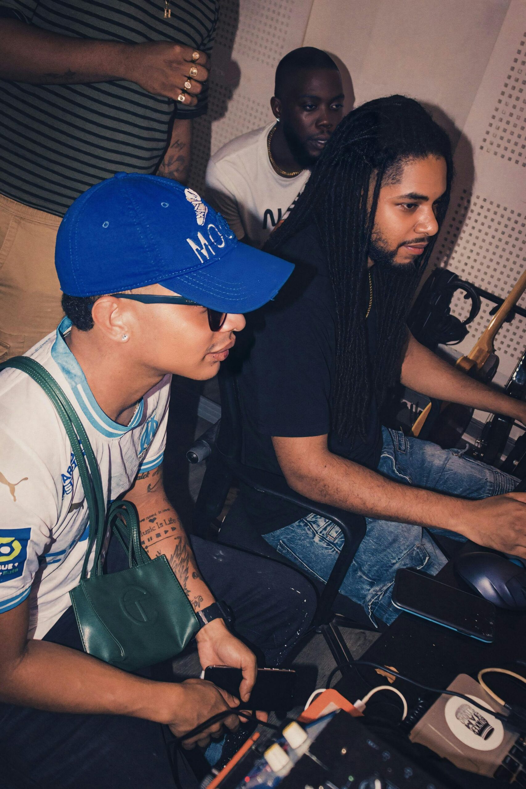 Music producers working together in a recording studio, creative collaboration.